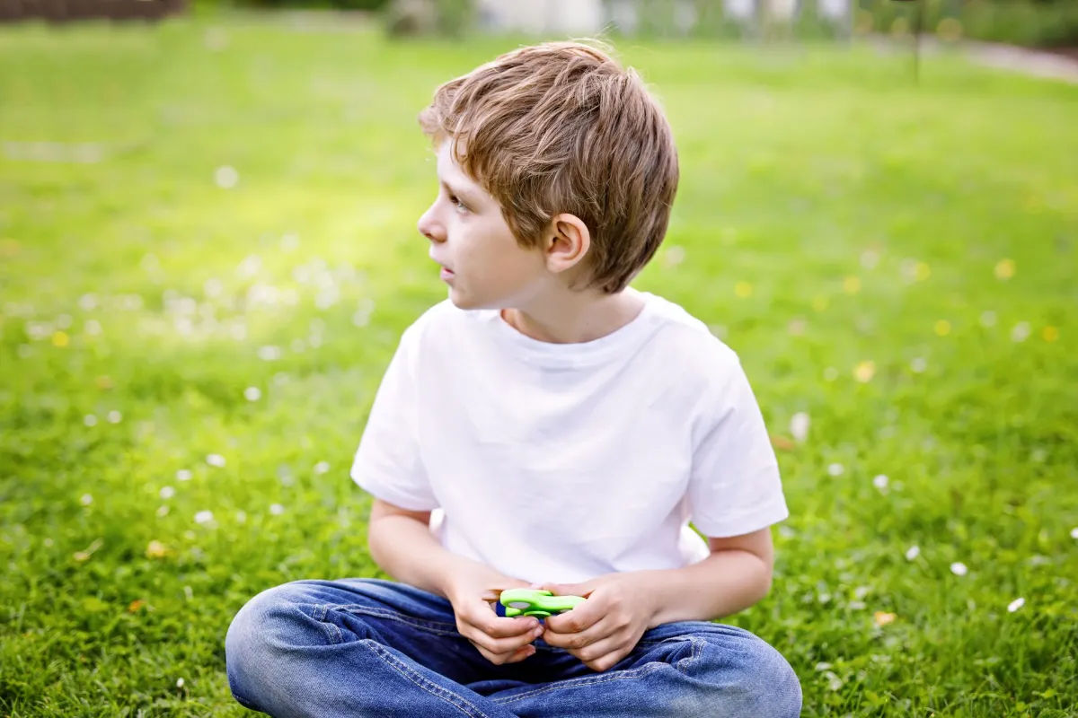 School kid playing with Tri Fidget Hand