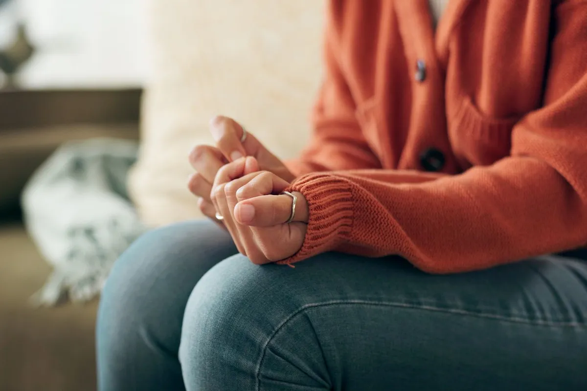 Closeup hands anxiety woman on sofa